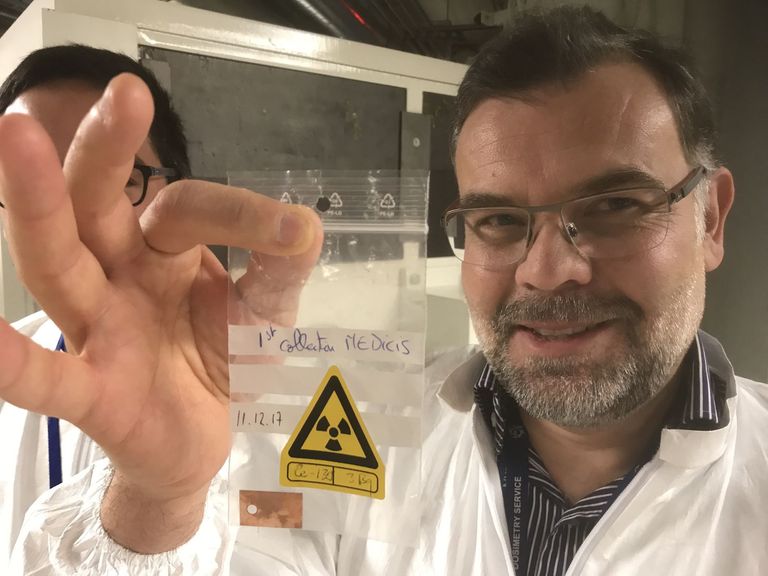 Stefano Marzari, a Mechanical engineer trained at the EIF (Engineering School of Fribourg), helped to set up the CERN-MEDICIS facility. In the picture, Marzari shows the first 155Tb isotope plate produced by CERN-MEDICIS on December 11, 2017. 155Tb has a half-life period of around five days; the radioactive emissions of the sample produced in December is almost completely finished.