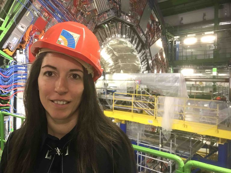Prof. Florencia Canelli (University of Zurich) in front of the CMS detector at CERN.